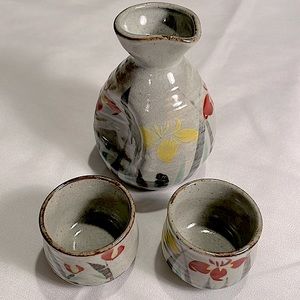 Stoneware Sake carafe, 2 Sake cups decorated with flowers, grass. Pretty colors!